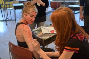 Artists Kat Deiner painting one of her models at the opening of the FORM Gallery in Calkin’s Hall.