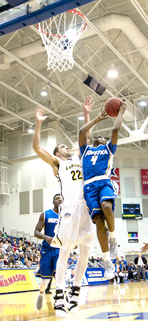 Chris Owens/The Chronicle Desure Buie (4) drives in for a layup attempt in Fridays victory over Canisius.