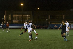 Megan McGuire/ Hofstra Chronicle Danny Elliott comes down on the ball with a Dragon player right on his back. Elliott notched six shots on Wednesday night.