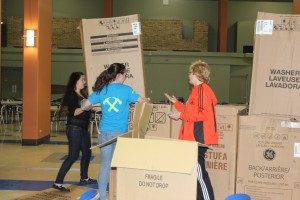 Sustainability Officer Teresa Greis helped students build makeshift homes in the Student Center dining room on Friday. The event was moved indoors due to rain.