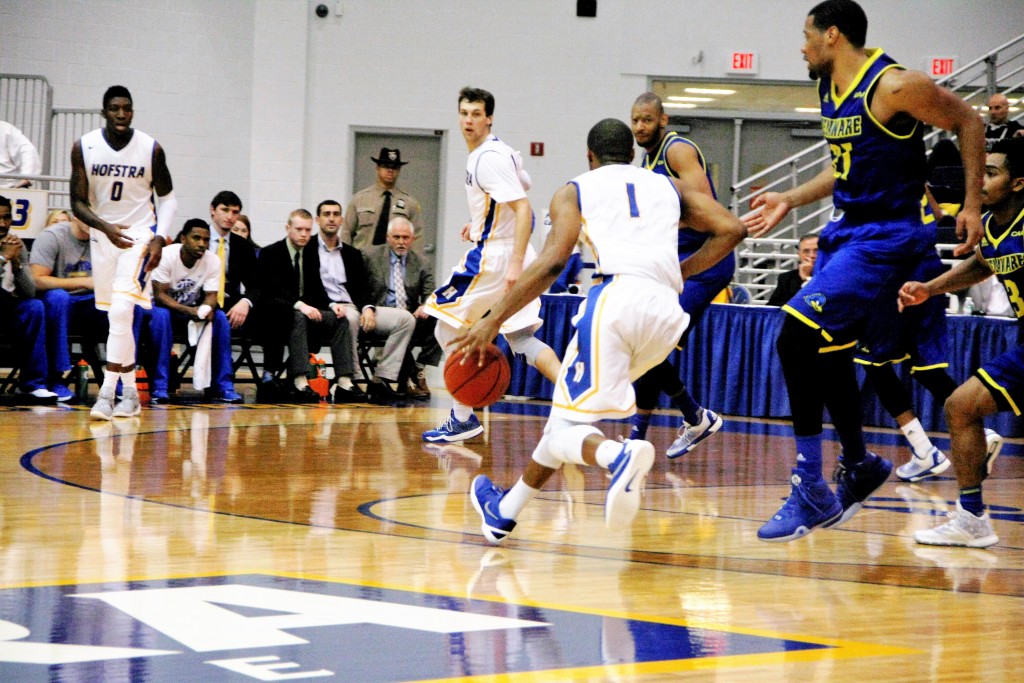 Mike Rudin/The Chronicle  Juan'ya Green drives the ball from the top of the key towards the hoop with Denton Koon and Malik Nichols surveying from the far corner.