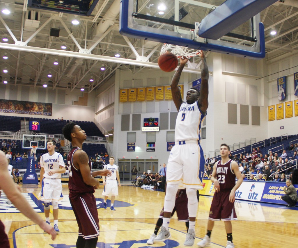 Victoria Mickens/The Chronicle Malik Nichols finishes off a dunk. He scored a career-high 16 points in a Pride uniform against Molloy.